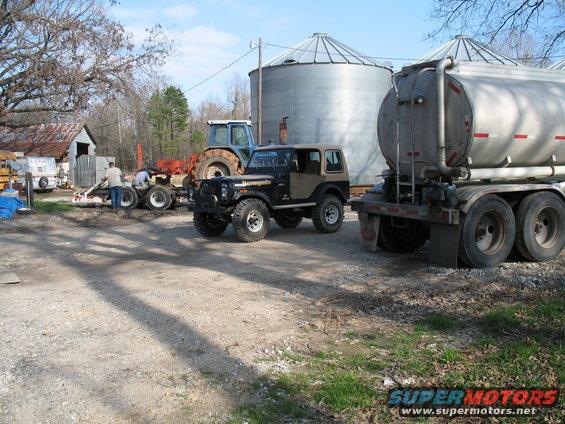 Renegade at bin site #2. Tanker on the right, homemade tractor transport trailer in the background. 8830 fullsize tractor with one of the tree planters hitched to it in tow.