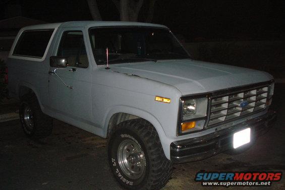 Gray 1980s Ford Bronco with aftermarket wheels and tires