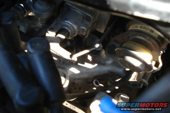Engine bay close-up with visible part numbers