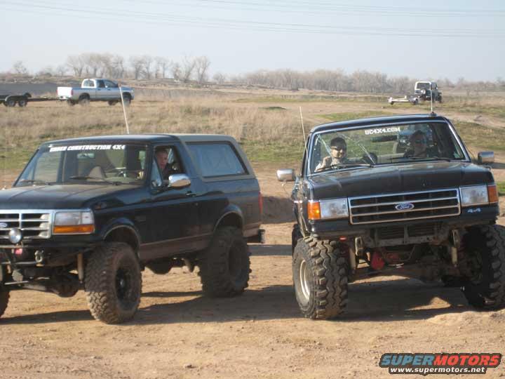 Black Ford Bronco with lifted suspension and large tires, viewed from a 3/4 front angle
