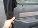 1981 Ford Bronco - Removing the interior door panel to access internal components.