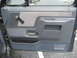 1981 Ford Bronco - Close-up of a truck's interior door panel, showing the fabric insert and armrest area.