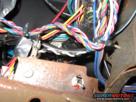 Close-up of a vehicle's wiring harness with a toggle switch labeled 'ON' and 'OFF'