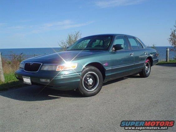 Green 1996 Mercury Grand Marquis parked by the water