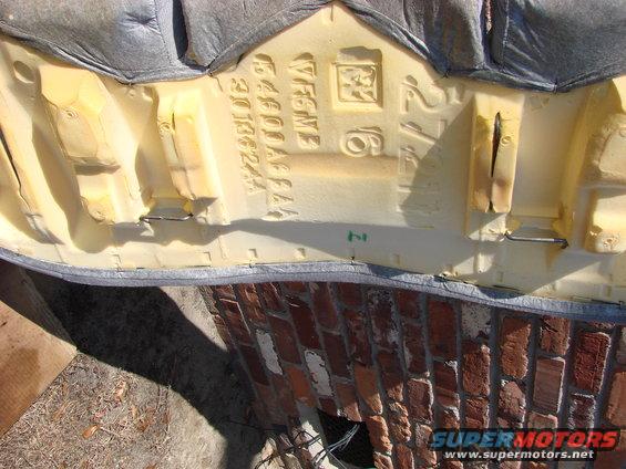 leak-repair-006.jpg This is what's on the underside of the back seat cushion.  See the wire?  It is what engages the hooks on the floor of the car.