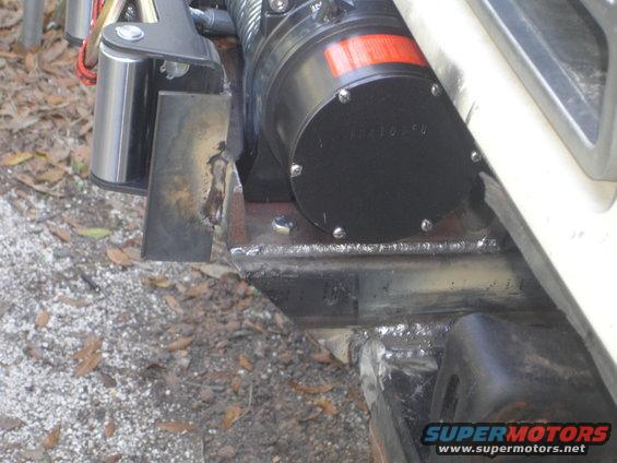 Winch mounted on custom steel brackets welded to a vehicle frame
