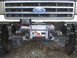 1989 Ford Bronco - Front view of a Ford truck with an aftermarket winch installed.