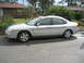 2001 Ford Taurus - Side view of a silver 2001 Ford Taurus sedan with a sunroof.
