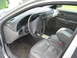 2001 Ford Taurus - The interior of a 2001 Ford Taurus, a gray dashboard, steering wheel with Ford logo, and leather seats.