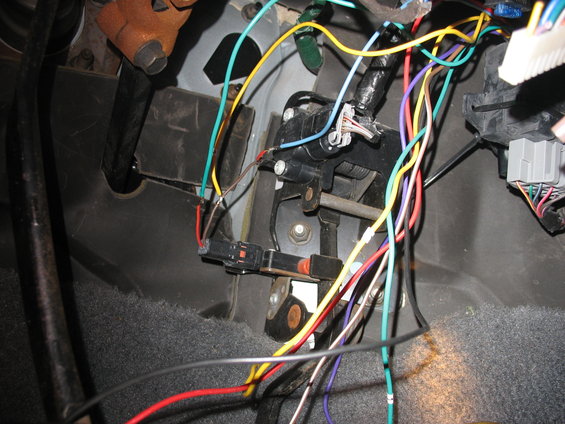 Vehicle interior wiring harness with multiple colored wires connected to a black sensor and grey connector