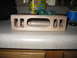 1995 Ford C-350 (Centurion Conversions) - A wooden part, possibly for an overhead console, sits on a countertop with various items in the background.