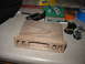 1995 Ford C-350 (Centurion Conversions) - A wooden part sits on a counter next to keys, a Six Flags tag, and a koozie.