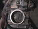 2007 Yamaha YZ450F - Close-up view of a motorcycle carburetor, showing internal components and external fuel lines.