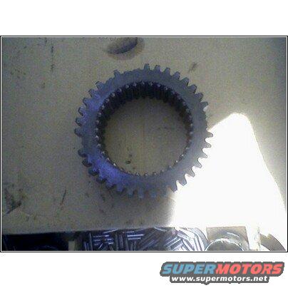 Transmission gear with internal splines, resting on a surface