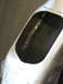1996 Ford Bronco - This image shows a close-up view of a metal part with a welded seam visible through an opening.