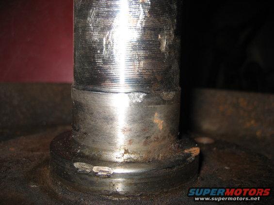 Metal spindle with threaded top and worn base