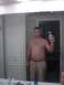 1900 Ford 427 - A man takes a mirror selfie while standing in front of bathroom cabinets.