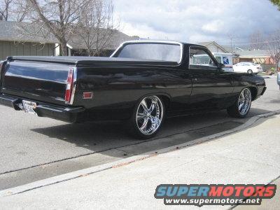 Black 1970 Ford Ranchero with chrome wheels, rear 3/4 view