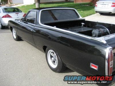 Black 1970 Ford Ranchero pickup truck, rear 3/4 view, parked on street