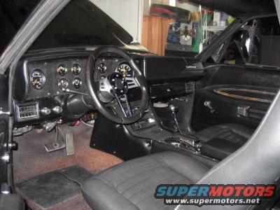 car interior with aftermarket steering wheel and gauges