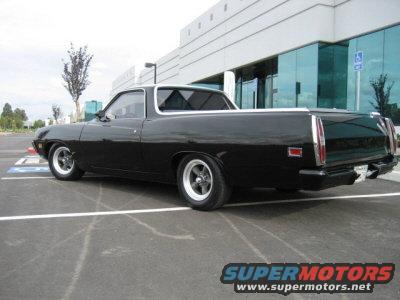 Black 1970 Ford Ranchero parked in a lot, rear 3/4 view