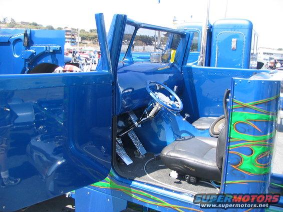 Blue semi-truck interior, custom flames on exterior panel