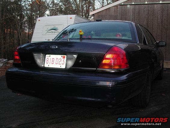 Dark 1998 Ford Crown Victoria rear view with license plate 81BD23