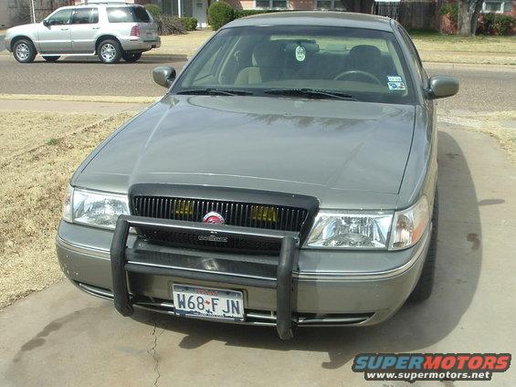 2003 Mercury Grand Marquis with push bar and another SUV in background