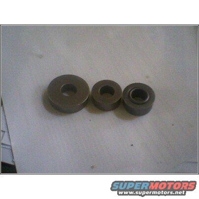 Three metal bushings of varying sizes on a light-colored surface