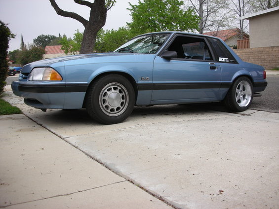 Blue 1990 Ford Mustang coupe with 5.0 badge on fender