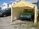 1975 Ford Bronco - A green 1975 Ford Bronco is parked under a temporary carport, with a black SUV visible to its left.