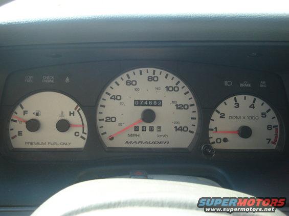 Car dashboard with speedometer, tachometer, fuel gauge, and temperature gauge. Odometer reads 074682. The speedometer indicates 'Marauder'