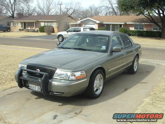 Gray 2003 Mercury Grand Marquis with push bar parked in driveway