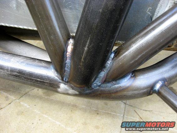 Close-up of welded metal tubes, likely part of a roll cage or custom frame