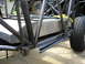 1995 Ford Bronco - The custom chassis of an off-road vehicle is shown, a large fuel tank and a tire.