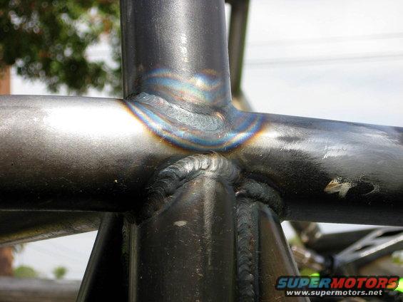 Welded steel tubing with heat discoloration, close-up