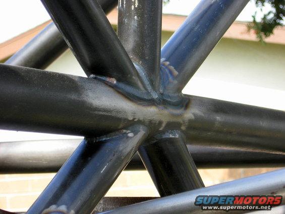 Roll cage with visible welds and "SUPERMOTORS.NET" watermark