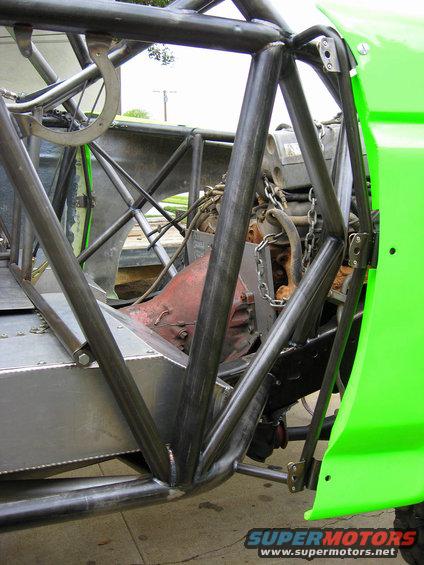 Custom roll cage and engine of a bright green off-road race vehicle