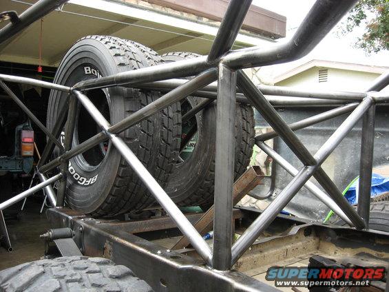 Roll cage structure with two BFGoodrich spare tires mounted inside. Part of an off-road race truck build