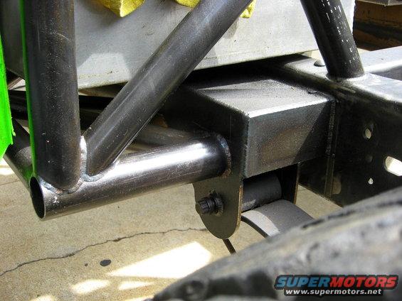 Roll cage tubing welded to a metal frame with leaf springs visible