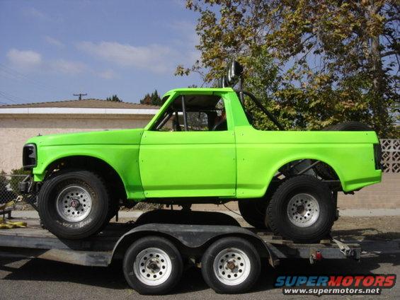 1995 Ford Bronco modified for off-road, painted lime green, on a trailer