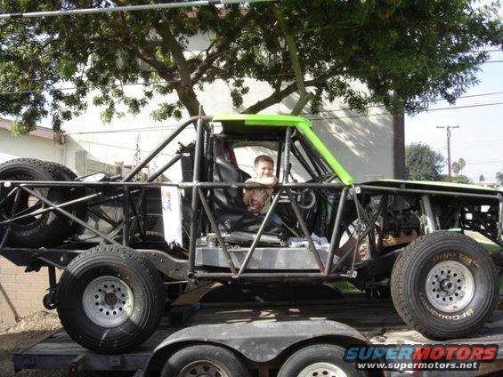 Custom buggy with roll cage and large tires, child in driver's seat