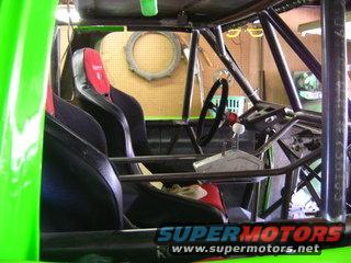 Interior of a custom off-road buggy with racing seats and a roll cage