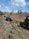 2008 International School Bus - Multiple off-road vehicles navigate a muddy trail with one Jeep requiring assistance from a tow strap.