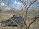2008 International School Bus - A black SUV navigates a wooded area with another vehicle following closely behind.