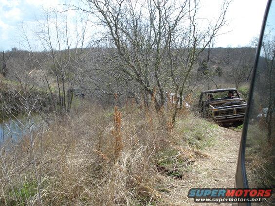 Old pickup truck driving off-road, 3q-front view