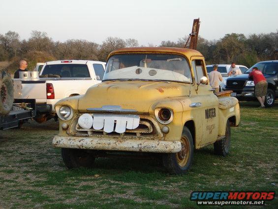 Yellow tow truck with Mater painted on the side and a cartoon face on the windshield