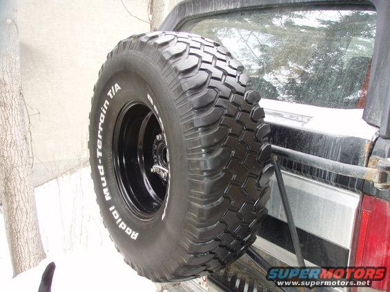 one of my old crappy 35" BFG M/T's as my spare.
so far,... the spare tire rack has held up to the weight.