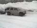 2000 Chevrolet Tahoe - Silver Chevrolet Tahoe parked in a snowy area with a large snowbank behind it.