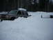 2000 Chevrolet Tahoe - This SUV is buried in a large snowdrift, indicating difficult winter driving conditions.